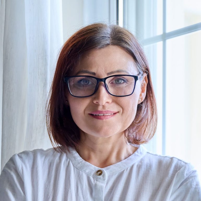 Portrait of a mature confident woman looking into the camera e1682561763563.jpg